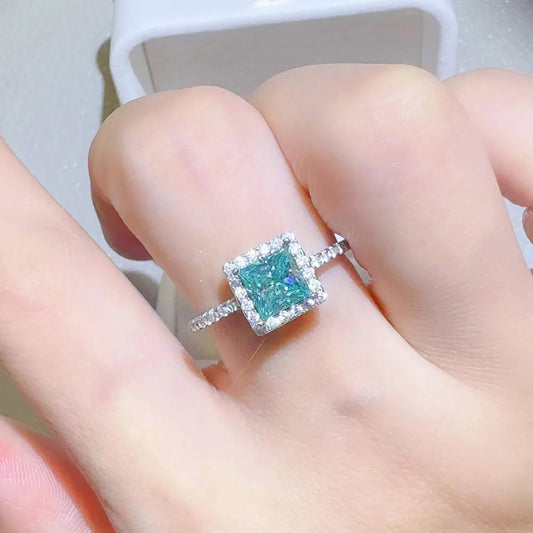Ring with a blue gemstone on a finger