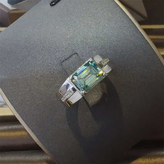 Top view of teal moissanite, rectangular cut with clean shoulders on polished 925 band