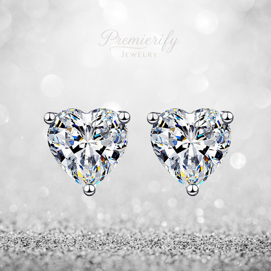 Heart-shaped diamond earrings on a silver background with 'Premierify Jewelry' branding.