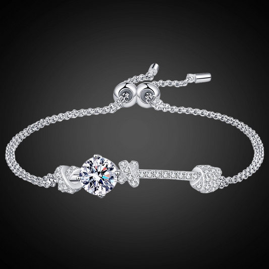 Silver bracelet with a central gemstone on a dark background