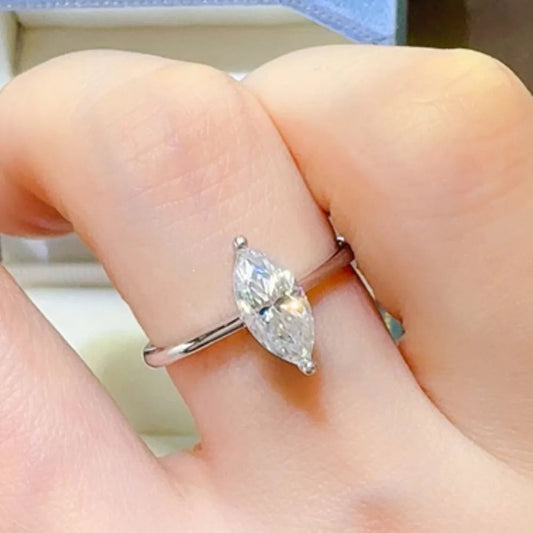 "Serenata Marquise 2 Carat Moissanite Solitaire Ring in platinum-plated 925 sterling silver with elongated marquise cut stone on prong setting."