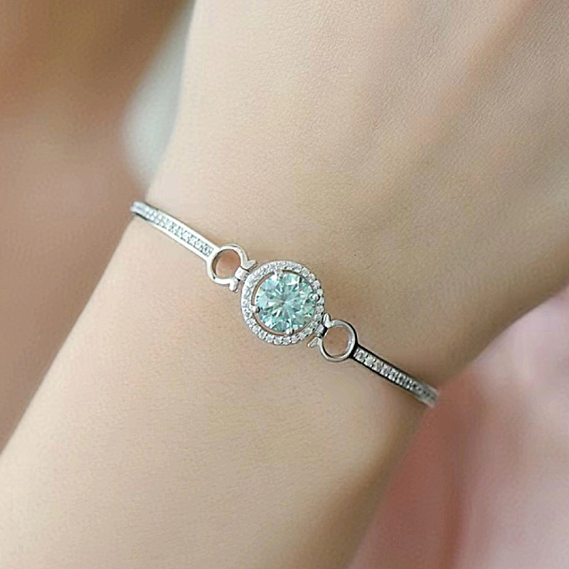 Sterling silver and moissanite bracelet on model’s wrist.