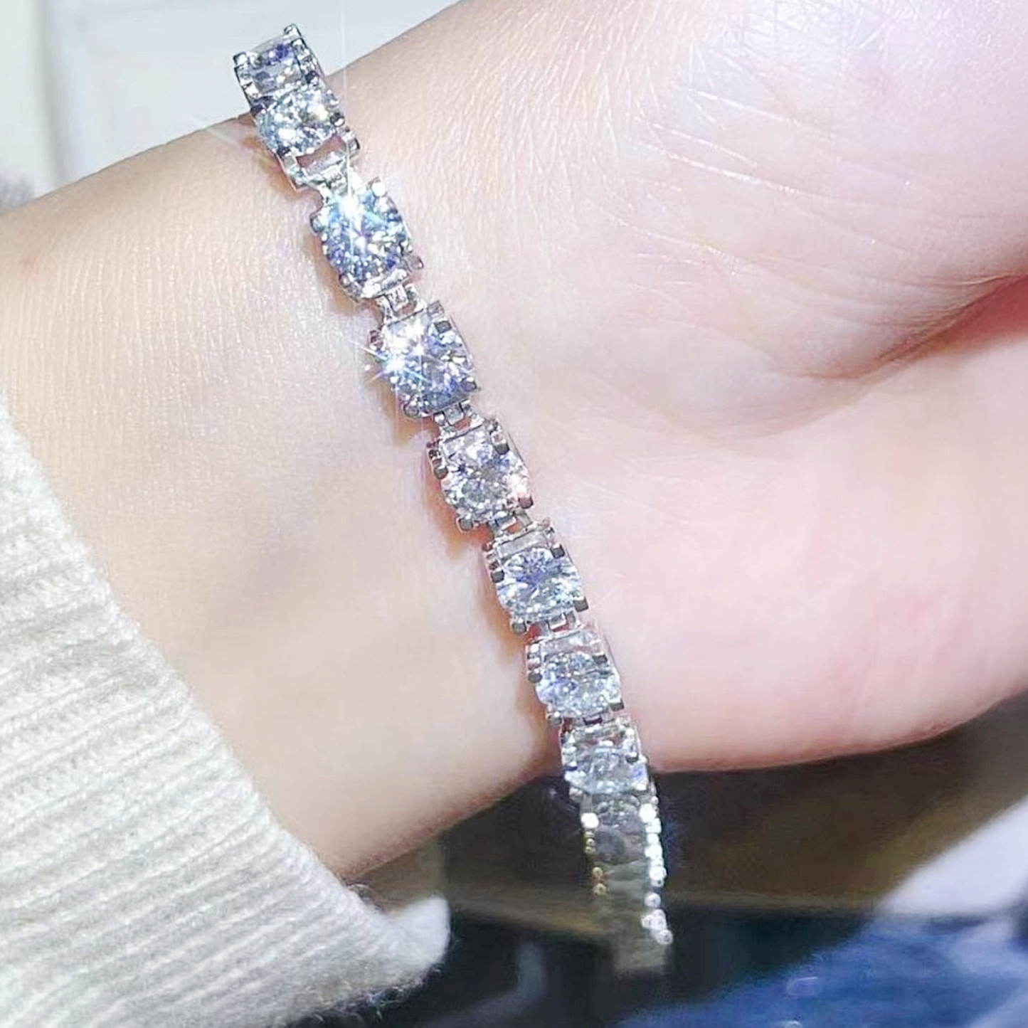Silver bracelet with clear stones on a person's wrist