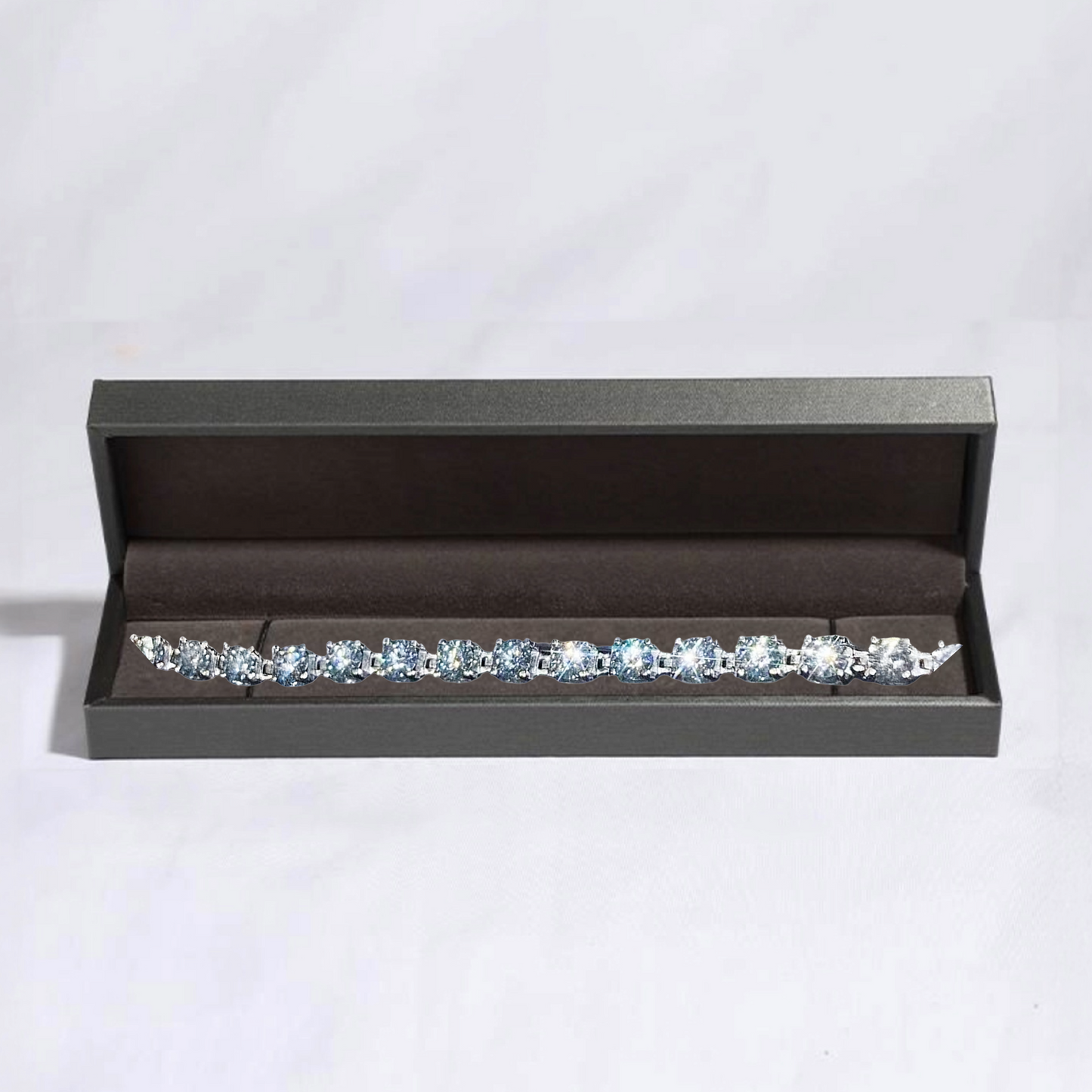 Diamond earring set in a black jewelry box on a light gray background