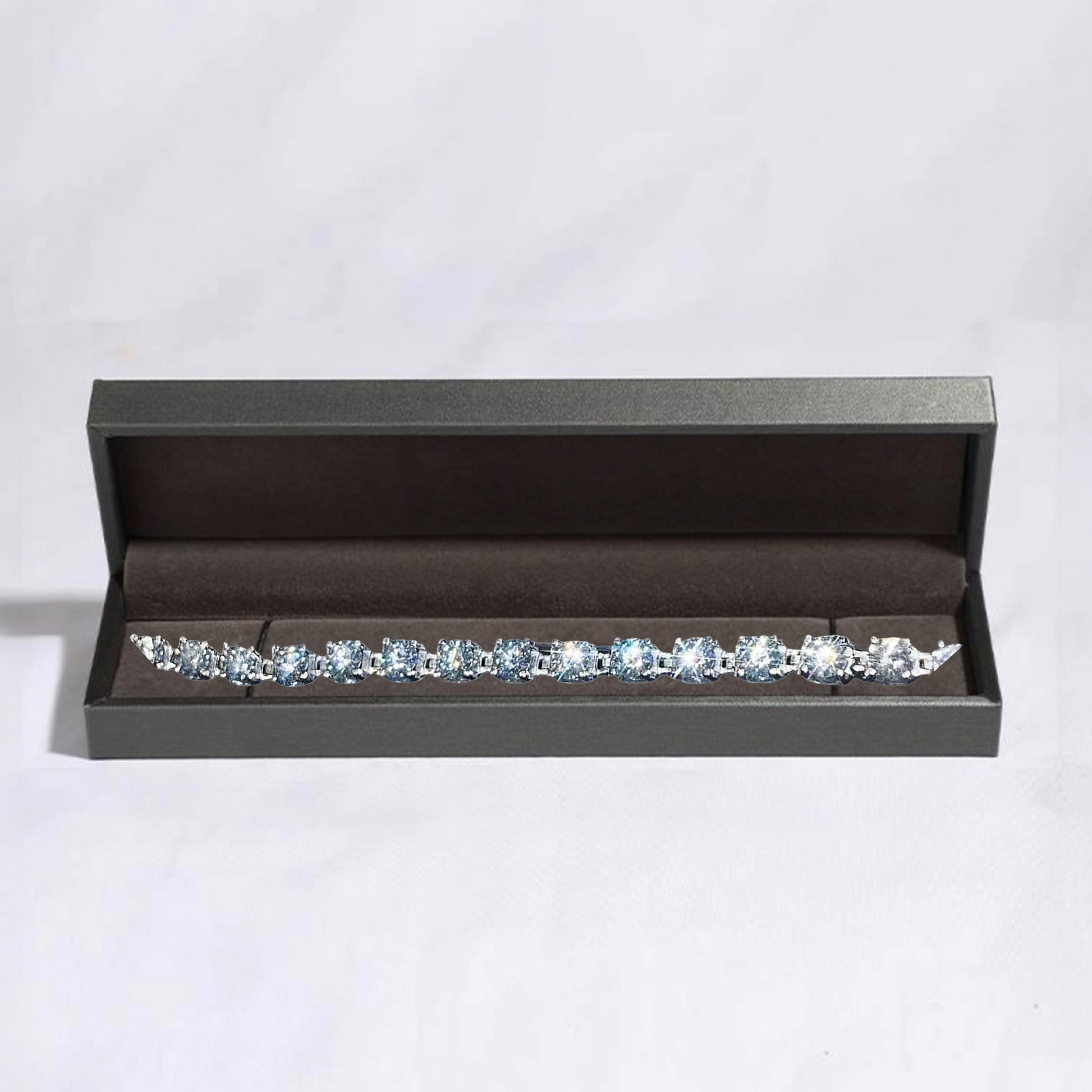 Diamond earring set in a black jewelry box on a light gray background