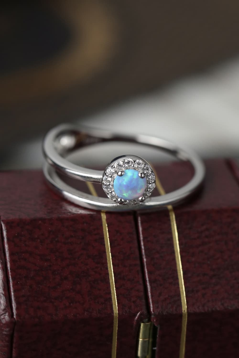 Close-up of a bright blue opal solitaire ring in platinum-plated 925
