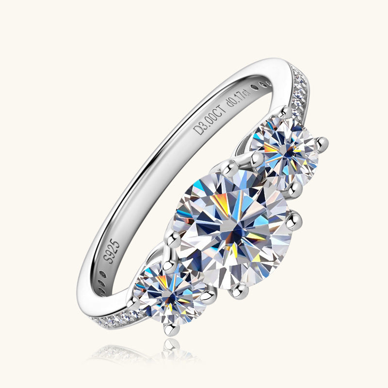 Eterna Trio™ 3 Carat Moissanite Ring in platinum-plated 925 sterling silver featuring three round-cut stones symbolizing past, present, and future.