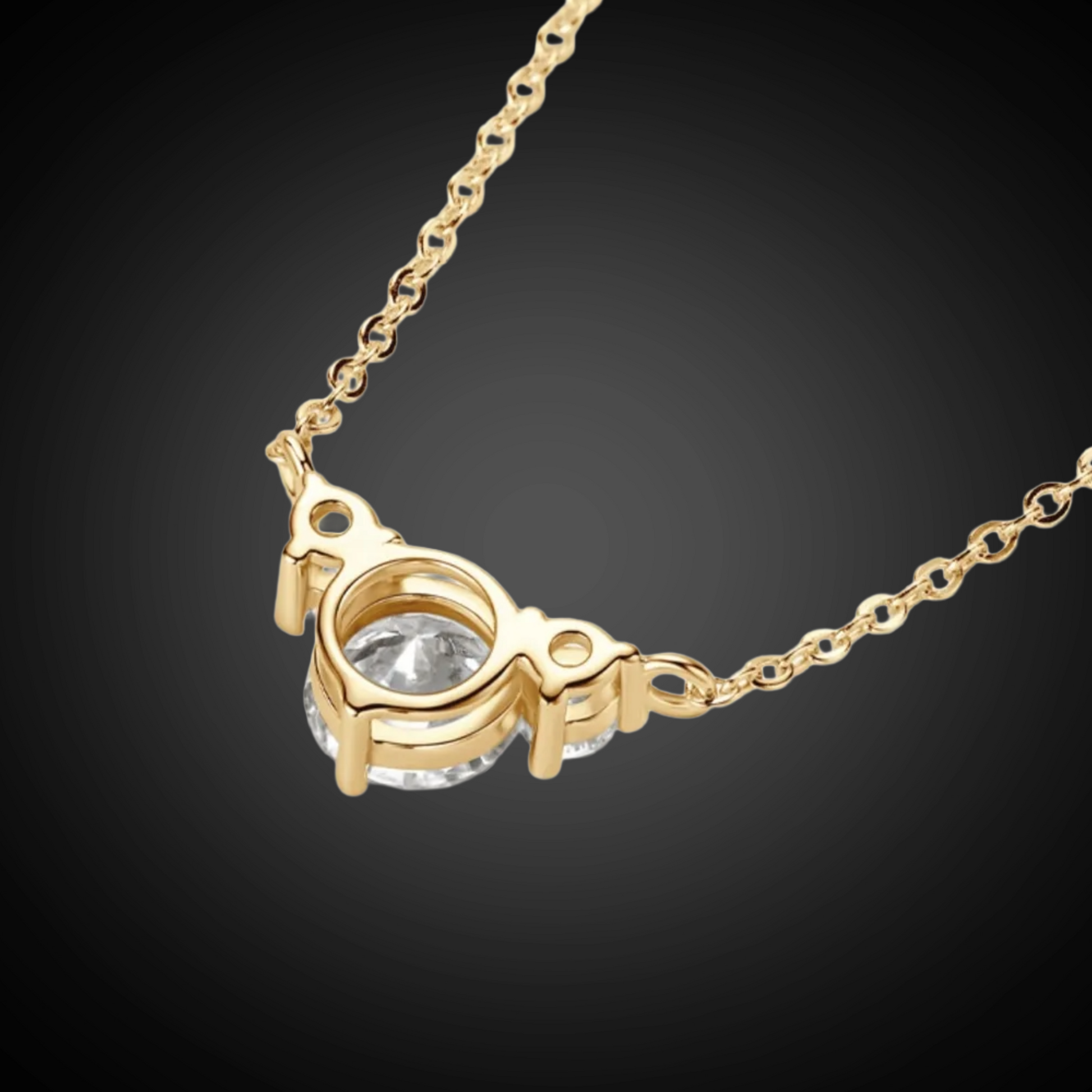 Gold necklace with a heart-shaped pendant on a black background