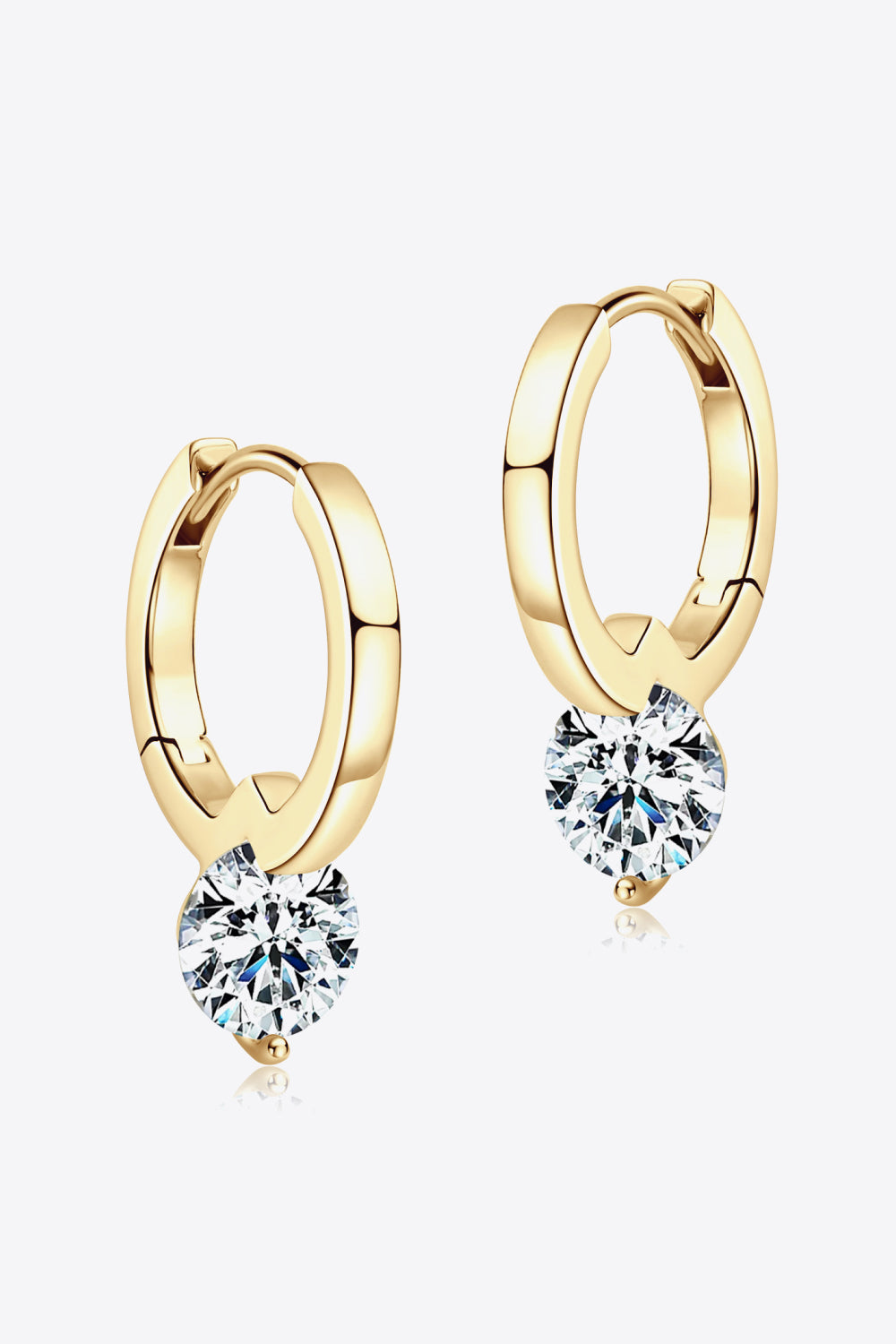 Gold hoop earrings with heart-shaped gemstones on a white background