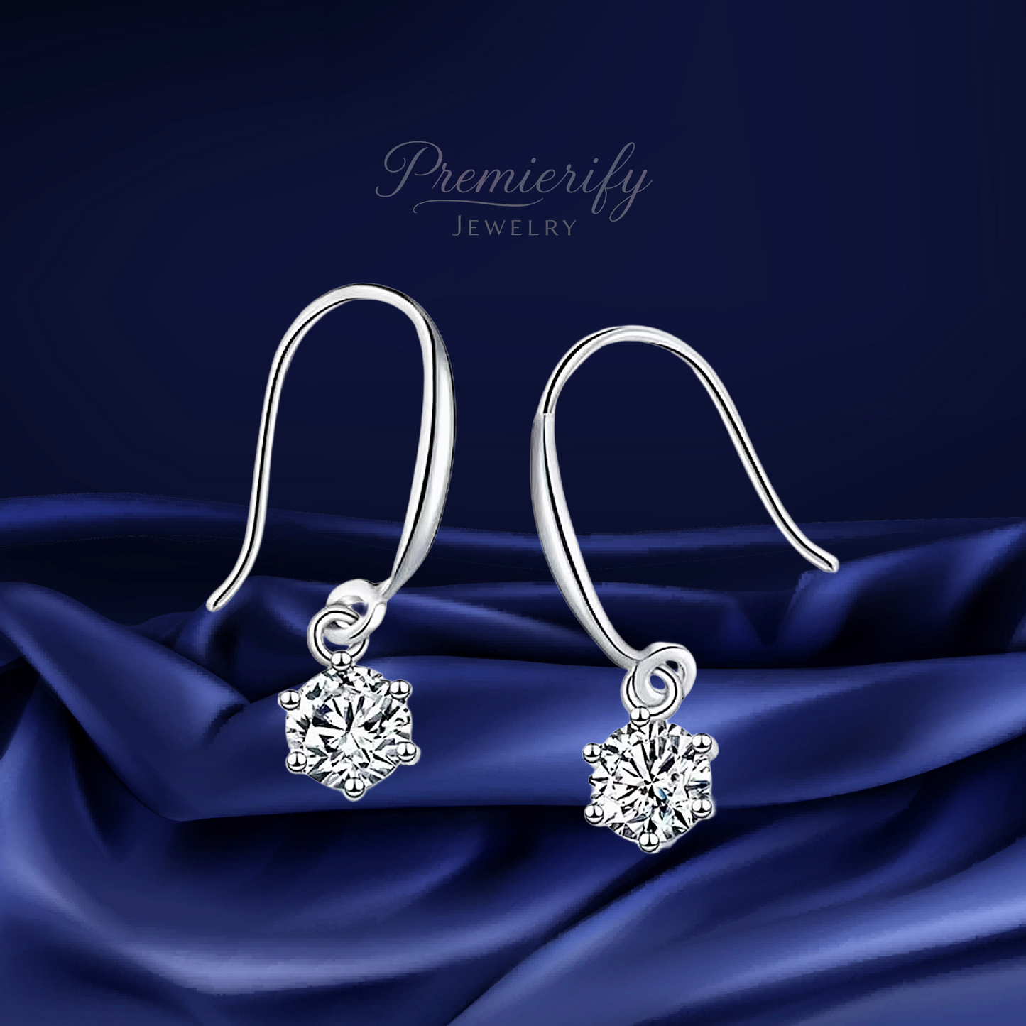 Silver earrings with diamond-like stones on a blue satin background, branded 'Premierify Jewelry'.