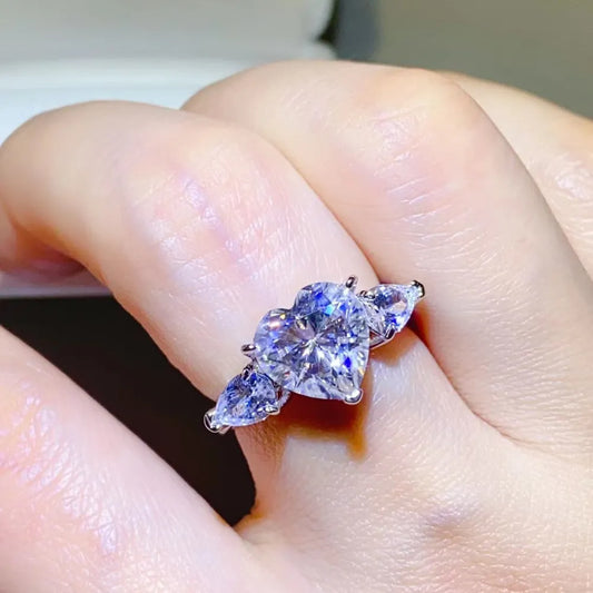 Amarisse Ring with 3 carat heart cut moissanite and trillion zircon accents set in platinum plated 925 sterling silver
