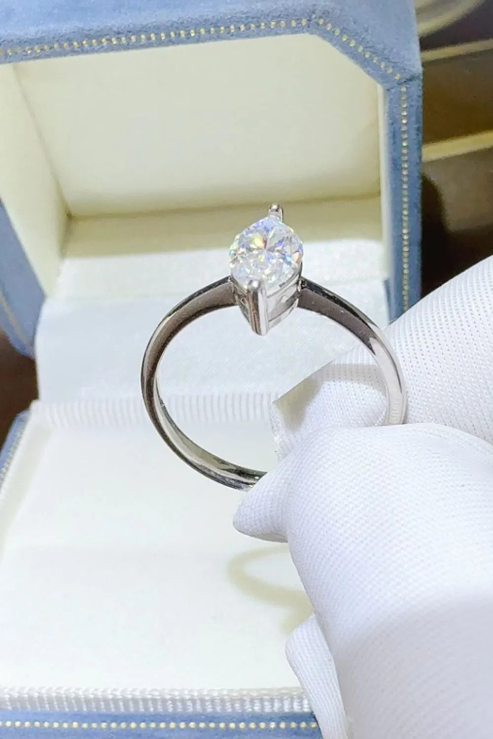 "Serenata Marquise 2 Carat Moissanite Solitaire Ring in platinum-plated 925 sterling silver with elongated marquise cut stone on prong setting."