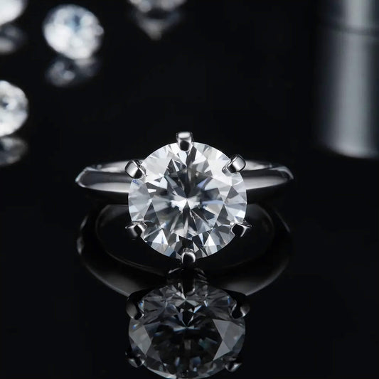 Diamond ring on a reflective surface with a dark background