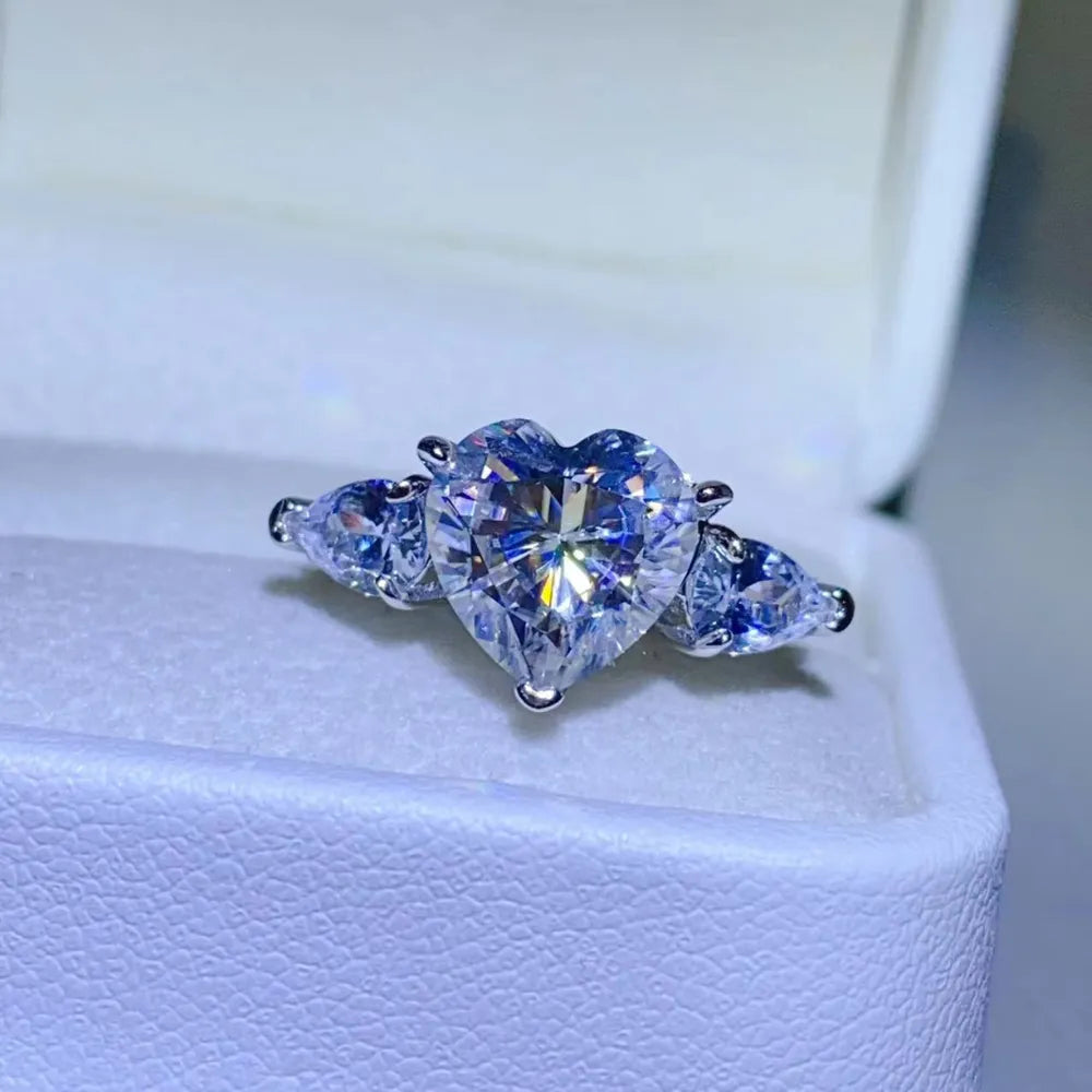 Amarisse Ring with 3 carat heart cut moissanite and trillion zircon accents set in platinum plated 925 sterling silver