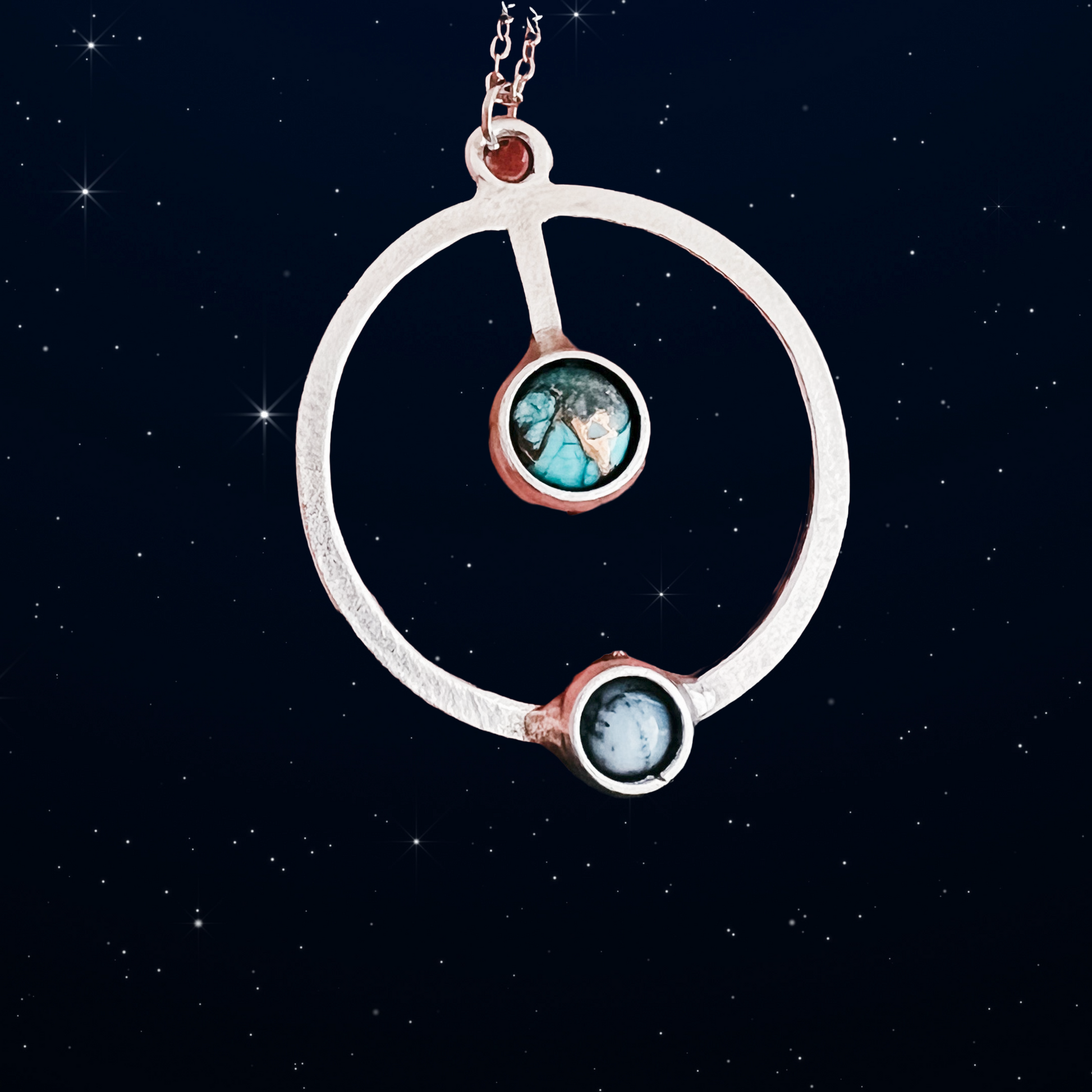 Necklace with circular pendant against a starry night sky background