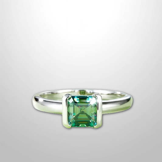 Sea-glass green 1 ct square moissanite bezel-set in platinum-plated 925 silver ring, front angle.