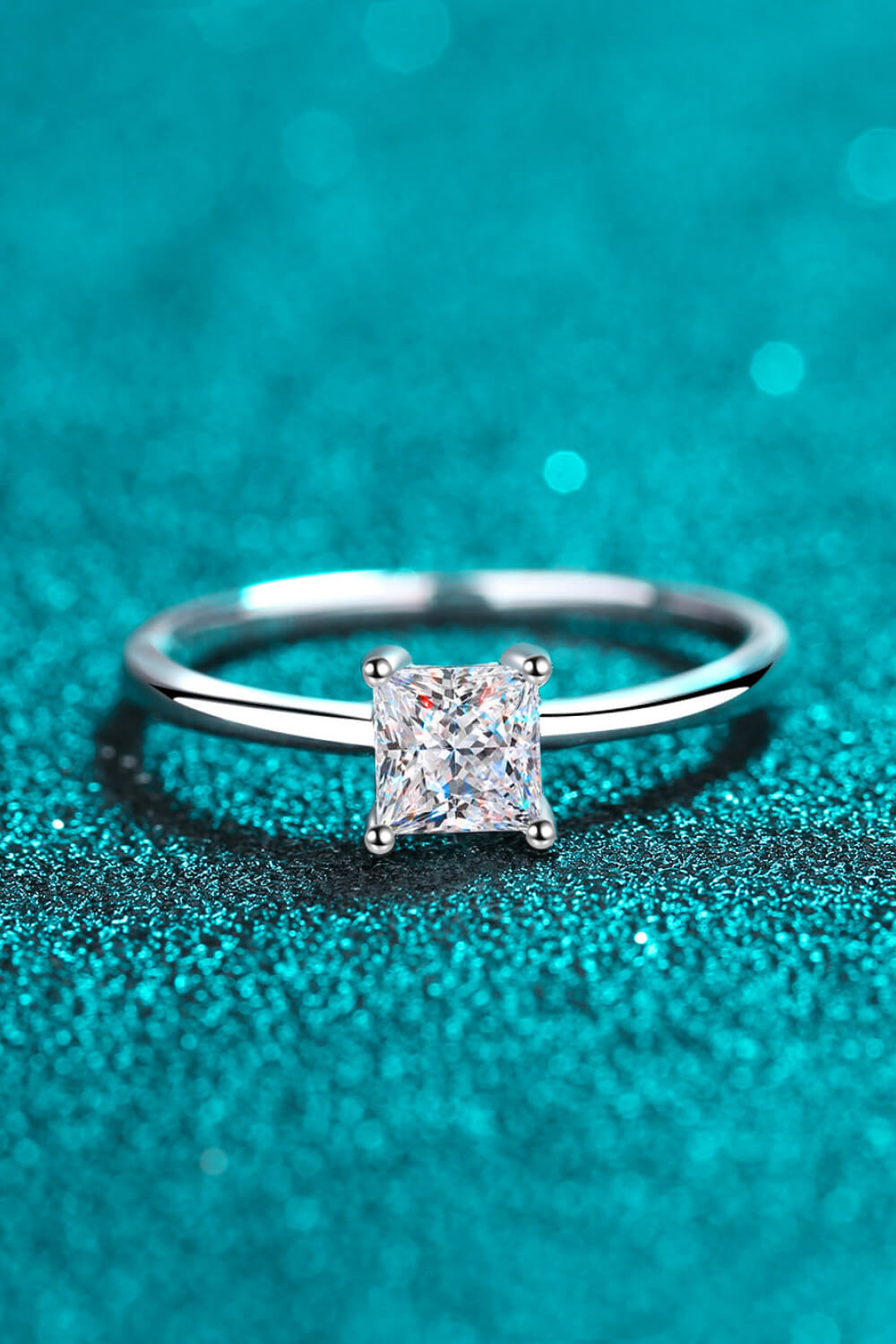 Auren™ princess-cut moissanite solitaire ring in platinum-plated 925 sterling silver with minimalist band.