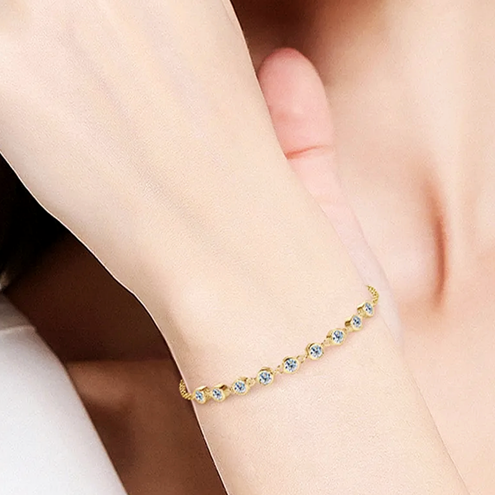 Gold bracelet with colorful stones on a wrist
