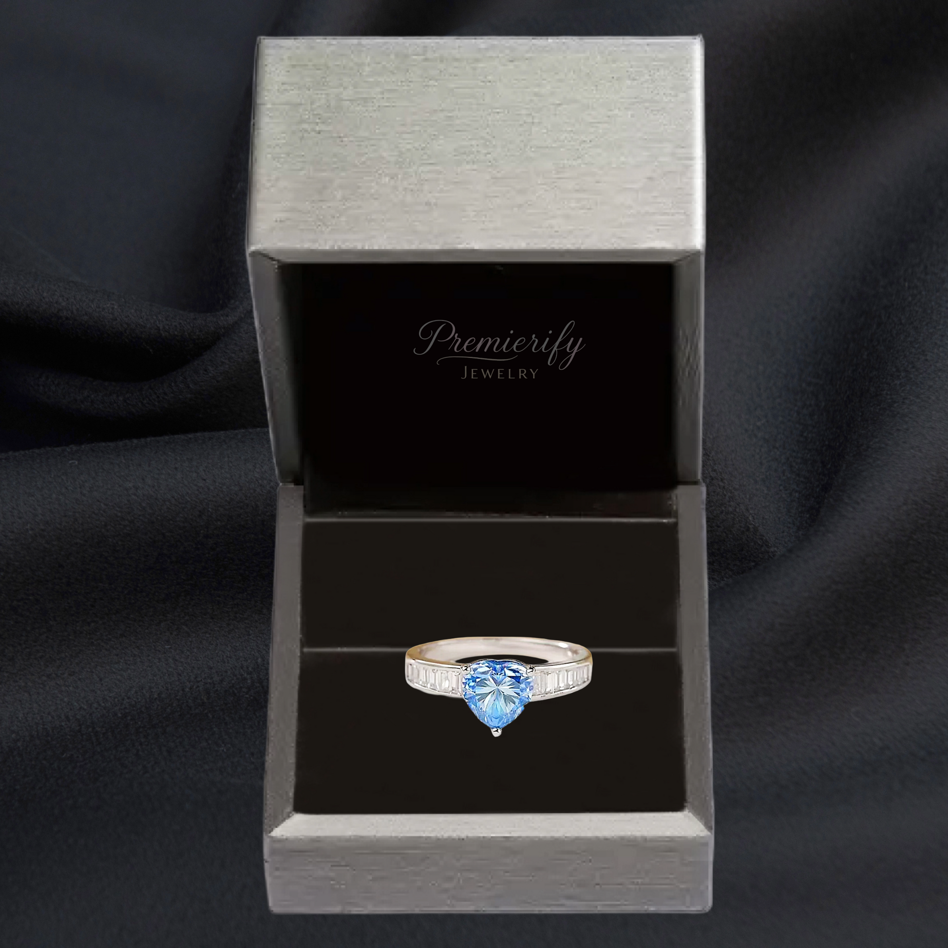 Ring with blue gemstone in a Premierify Jewelry box on a black background
