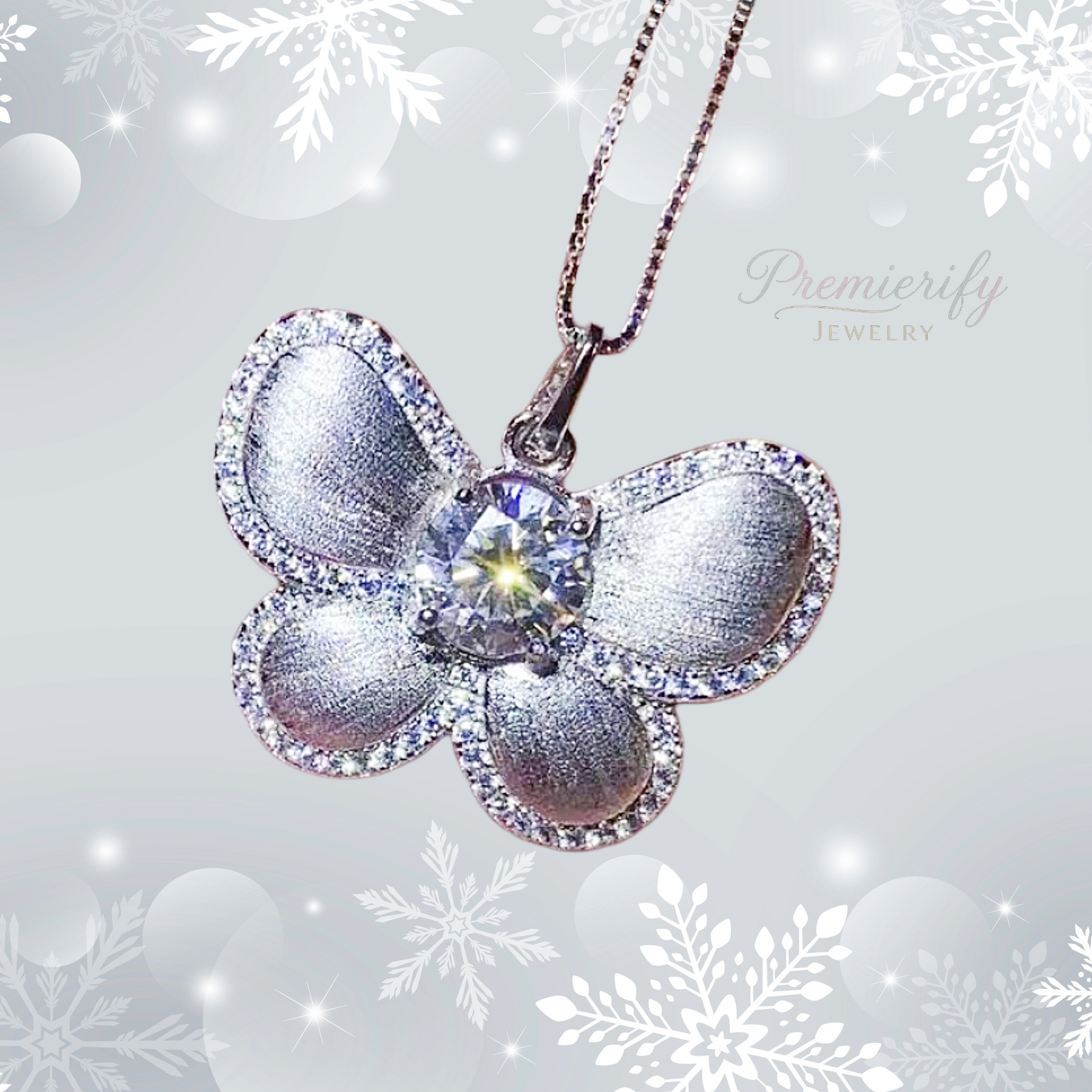 Butterfly-shaped silver pendant with a central gemstone on a snowflake-themed background, featuring the brand 'Premierify Jewelry'.