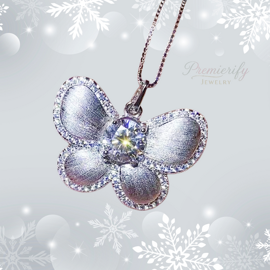 Butterfly-shaped silver pendant with a central gemstone on a snowflake-themed background, featuring the brand 'Premierify Jewelry'.