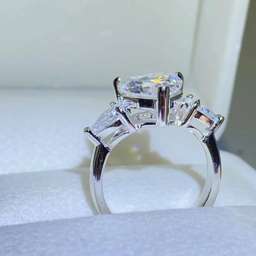 Amarisse Ring with 3 carat heart cut moissanite and trillion zircon accents set in platinum plated 925 sterling silver