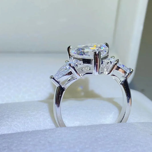 Amarisse Ring with 3 carat heart cut moissanite and trillion zircon accents set in platinum plated 925 sterling silver