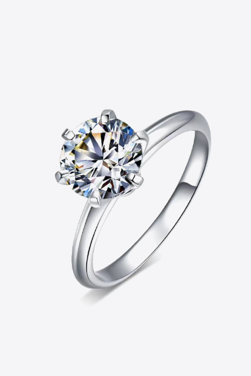 Studio flat lay of Premierify™ Kaitlyn Ann ring – classic round-cut moissanite in luxe solitaire setting