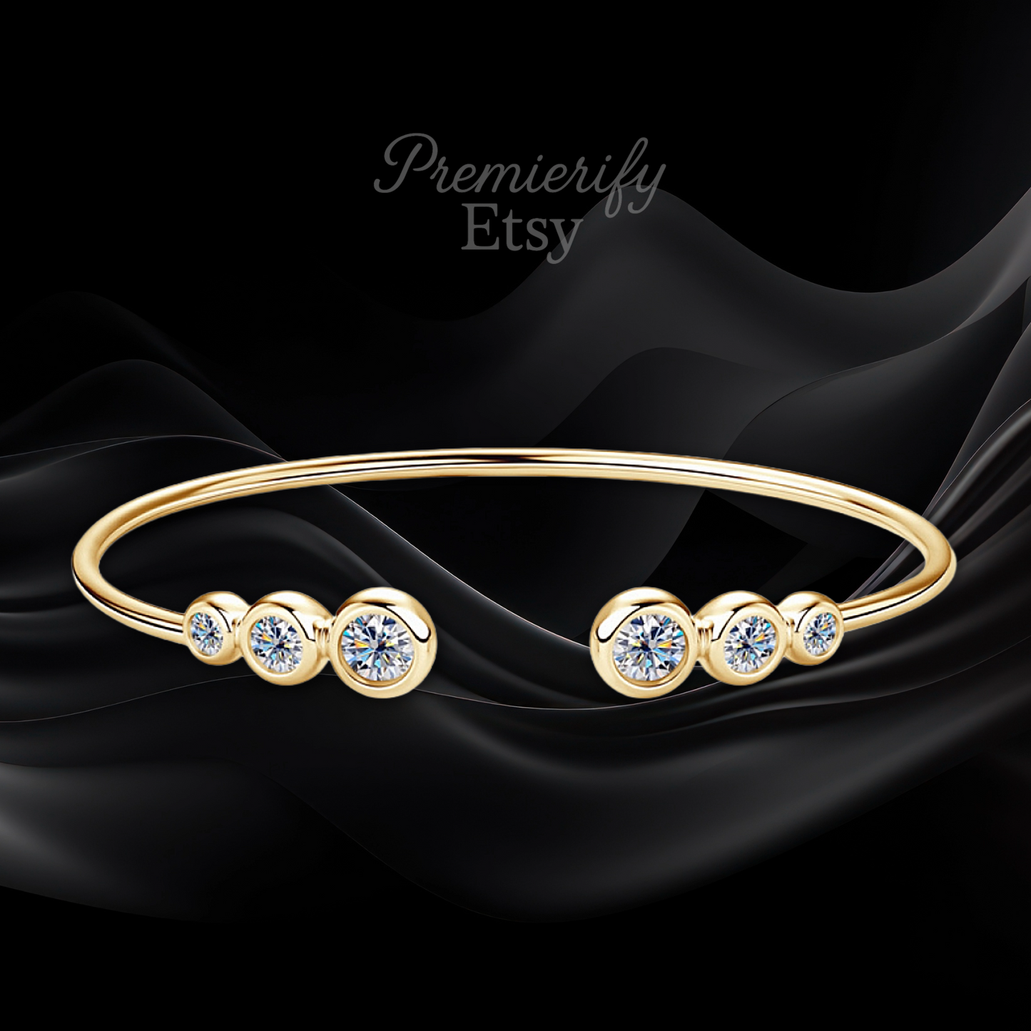 Gold bracelet with crystals on a black fabric background