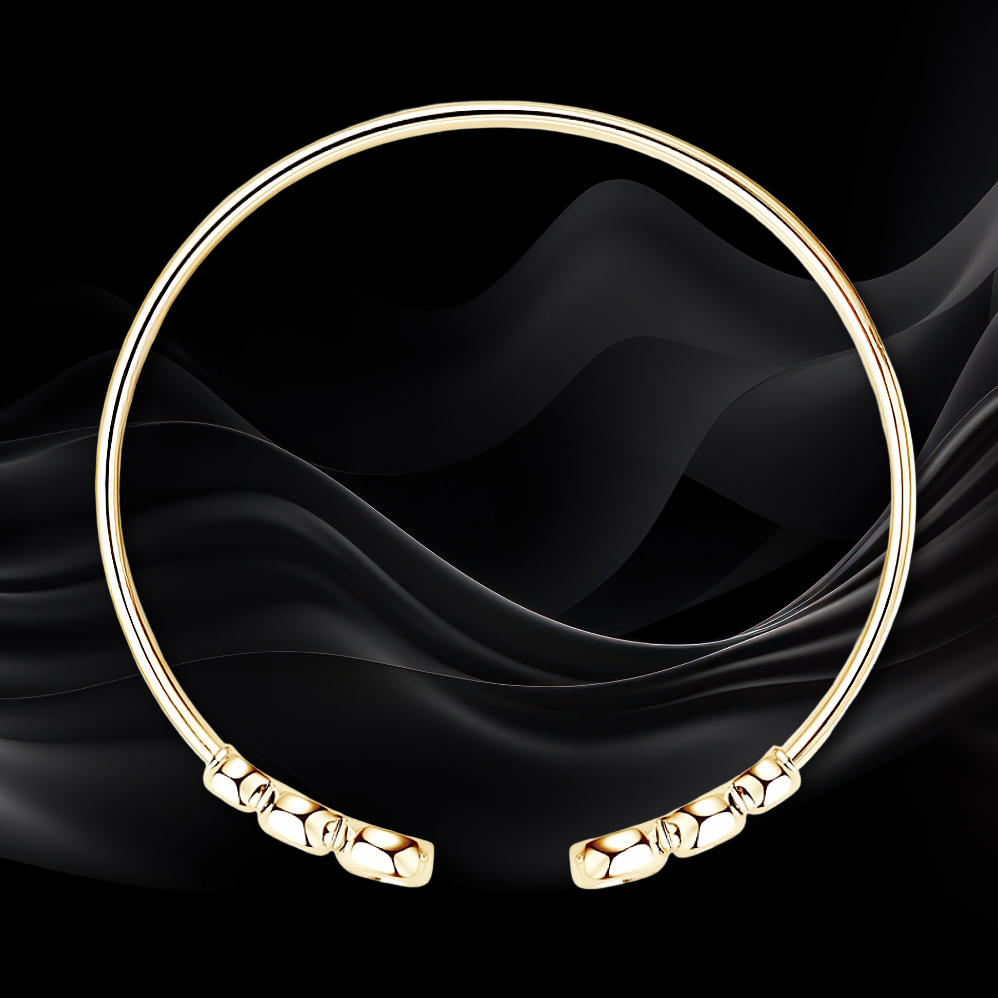 Gold bracelet on a black fabric background