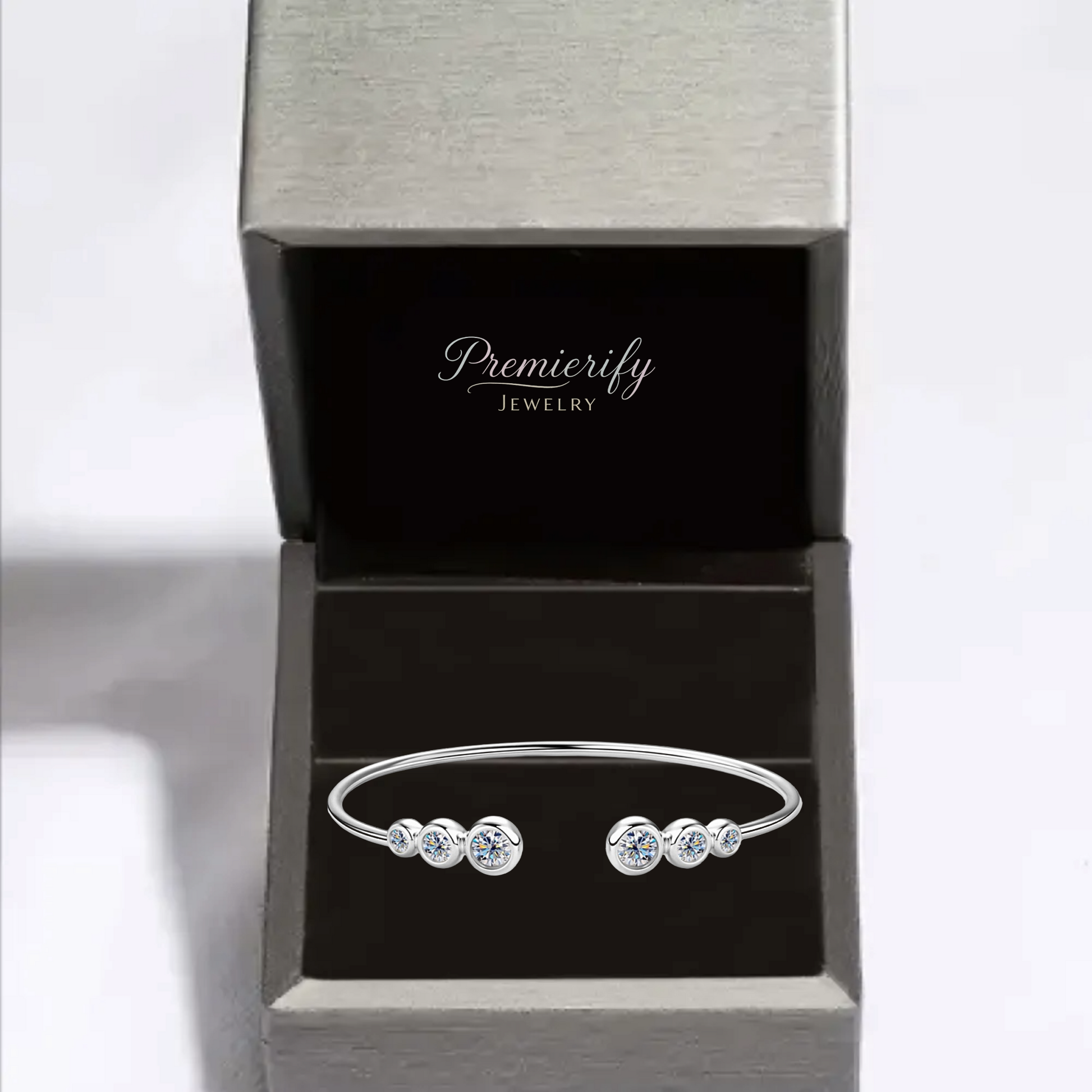 Silver bracelet with clear stones in an open Premierify Jewelry box on a white background