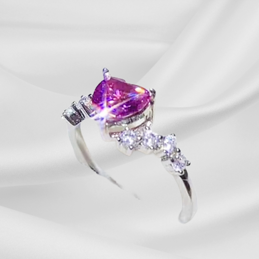 Silver ring with a purple gemstone on a white background