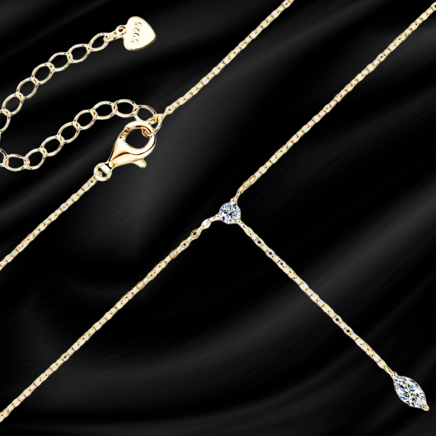 Gold chain necklace with a clasp on a black satin background