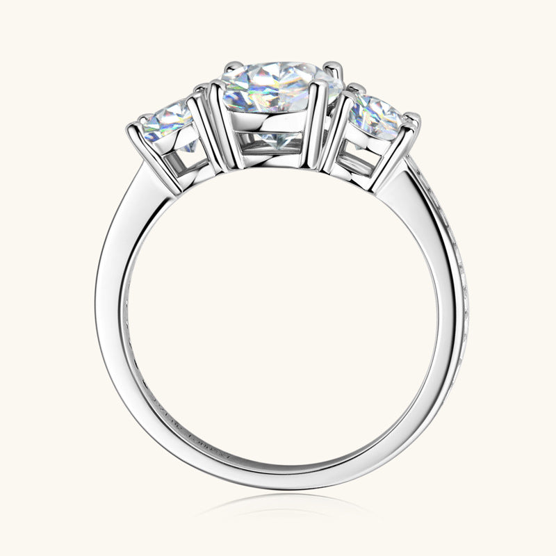 Eterna Trio™ 3 Carat Moissanite Ring in platinum-plated 925 sterling silver featuring three round-cut stones symbolizing past, present, and future.
