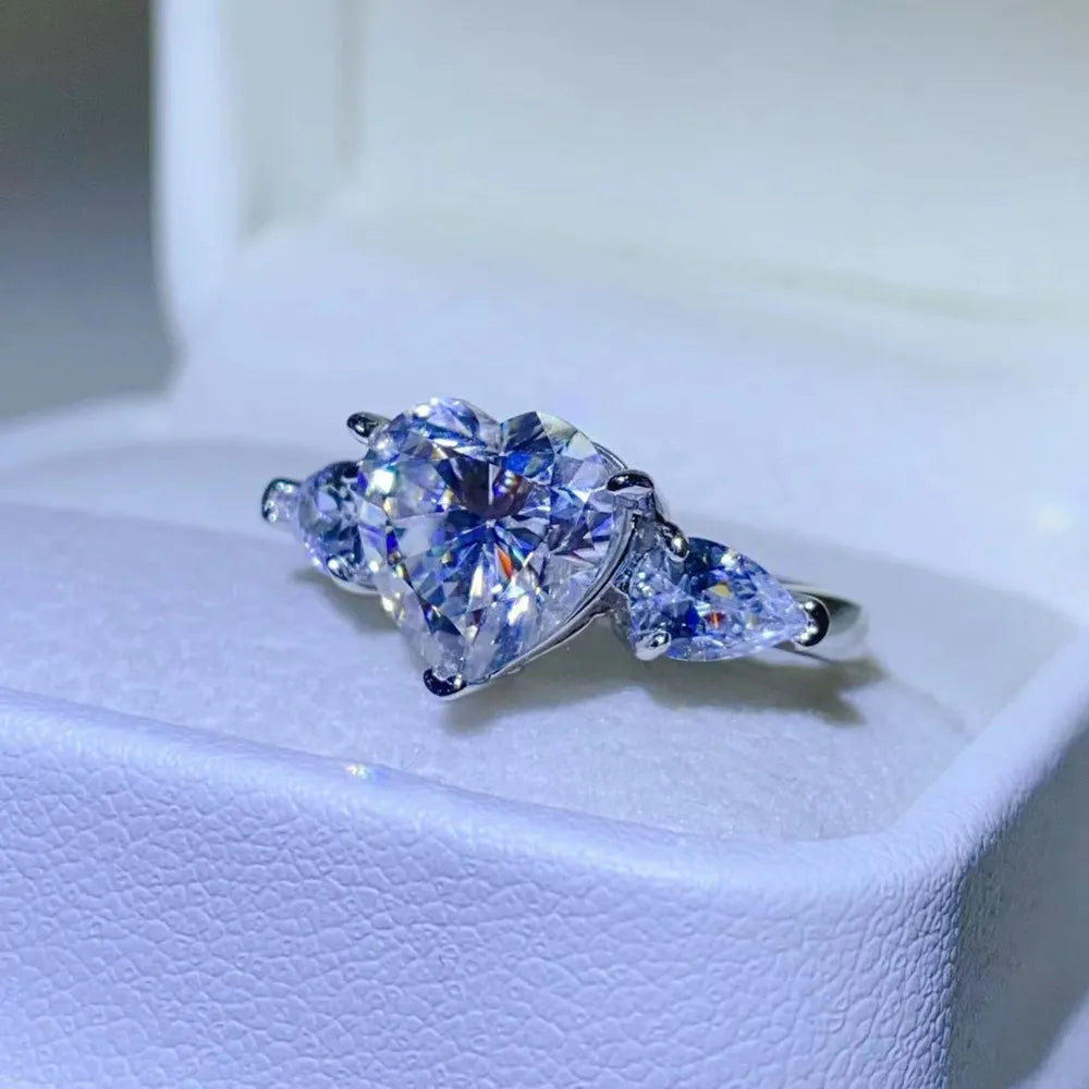 Amarisse Ring with 3 carat heart cut moissanite and trillion zircon accents set in platinum plated 925 sterling silver