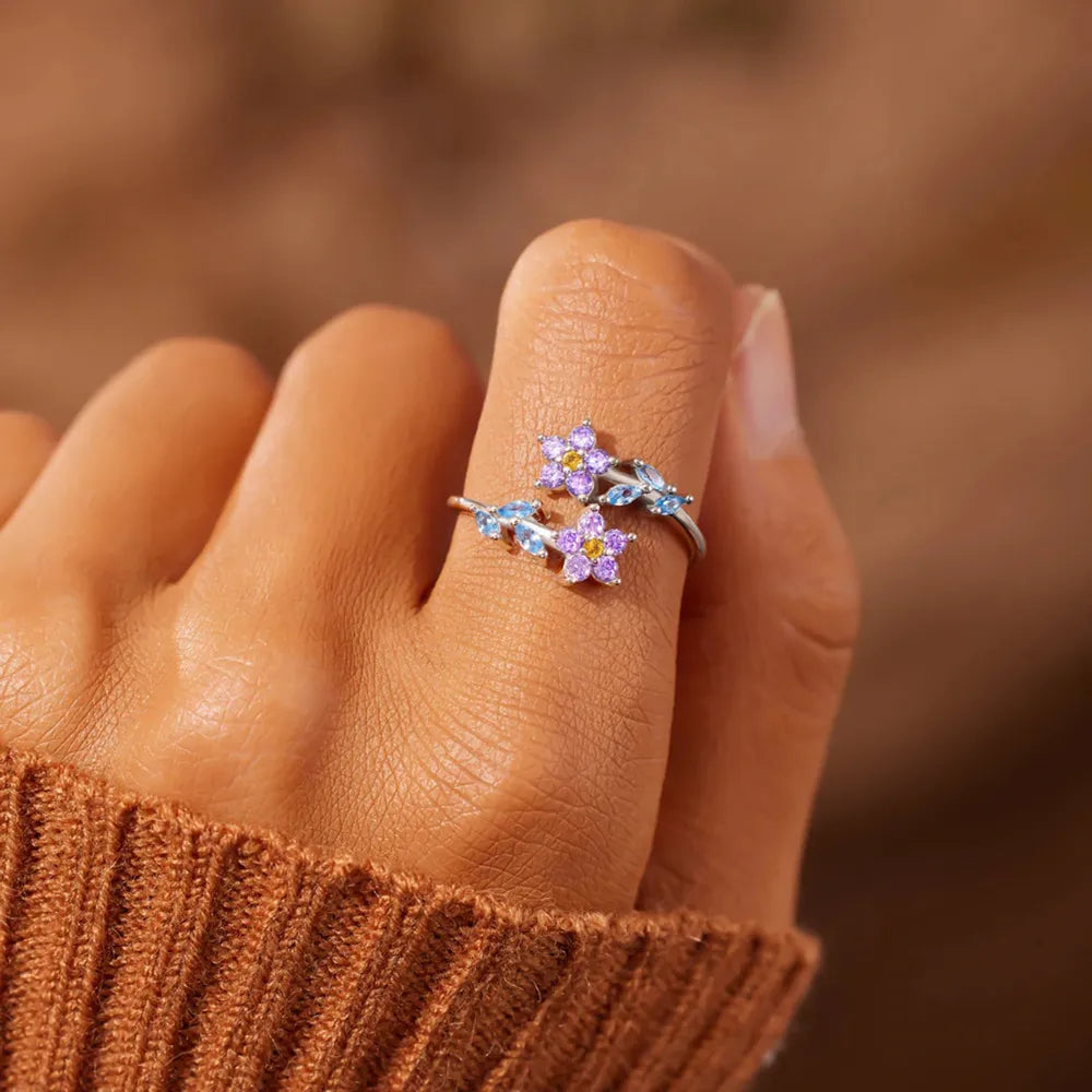 Starlit Petal™ inlaid zircon floral ring in 925 sterling silver on hand.