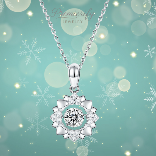 Silver flower and heart pendant necklace on a teal background with snowflakes