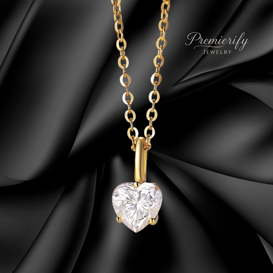 Gold necklace with a heart-shaped diamond pendant on a black fabric background, featuring the brand 'Premierify Jewelry'.
