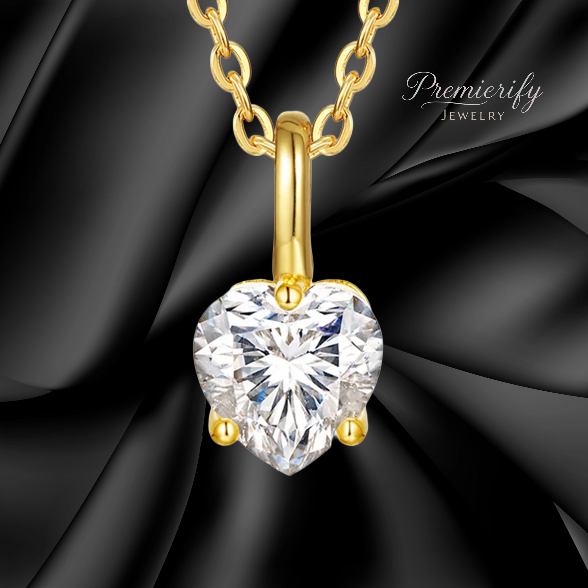 Gold necklace with a heart-shaped diamond pendant on a black fabric background