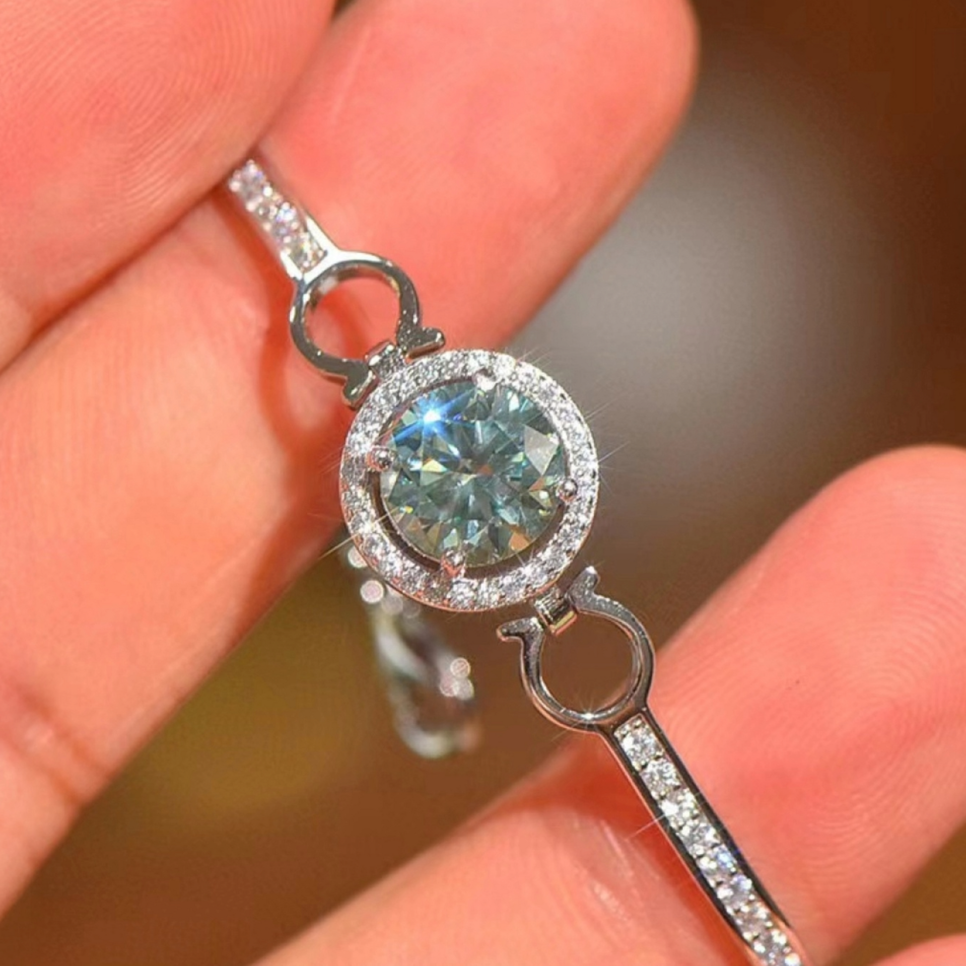 Person holding tennis bracelet.