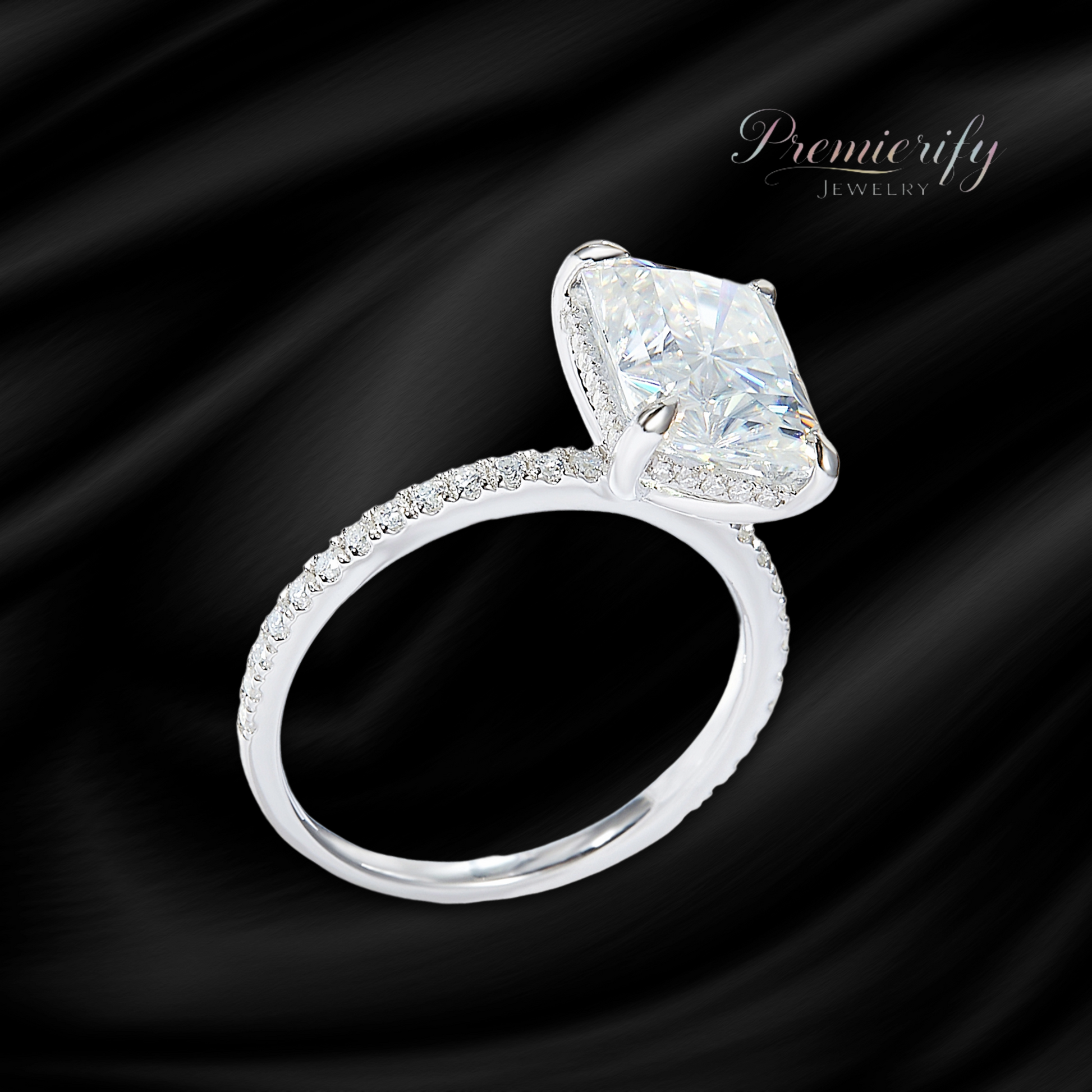 Diamond ring with a large central gemstone on a black satin background, featuring the brand 'Premierify Jewelry'.