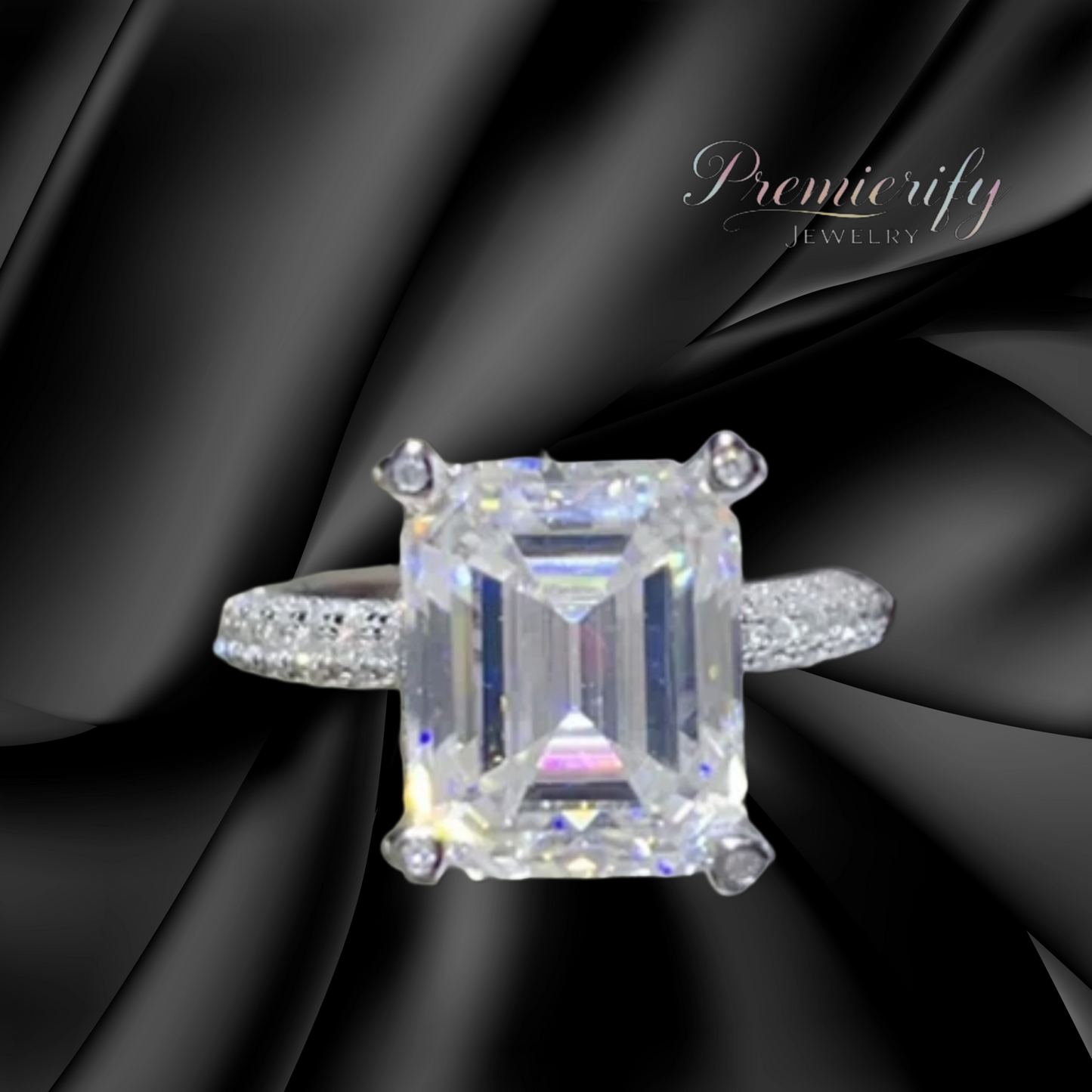 Diamond ring with a large central gemstone on a black fabric background, featuring the brand 'Premierify Jewelry'.