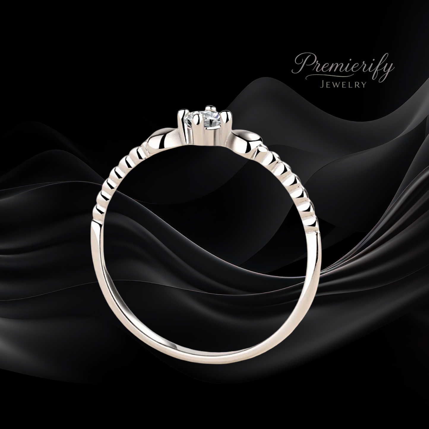 Silver ring with a diamond on black fabric, branded 'Premierify Jewelry'.