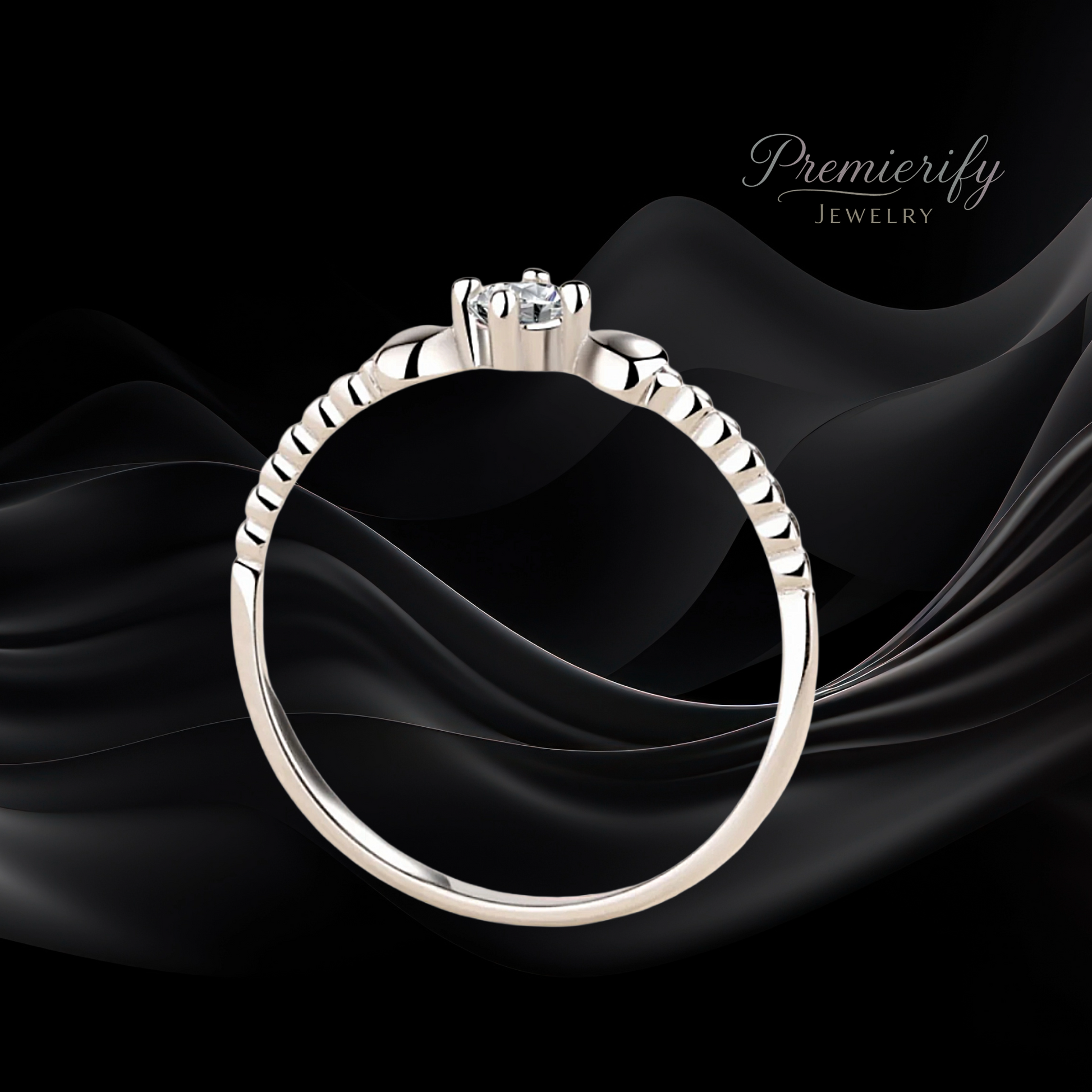 Silver ring with a diamond on black fabric, branded 'Premierify Jewelry'.