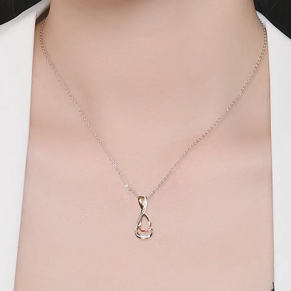 Silver necklace with a unique pendant on a mannequin