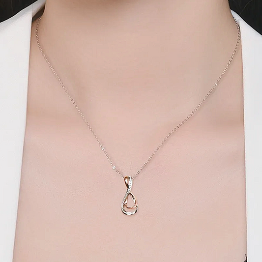 Silver necklace with a unique pendant on a mannequin
