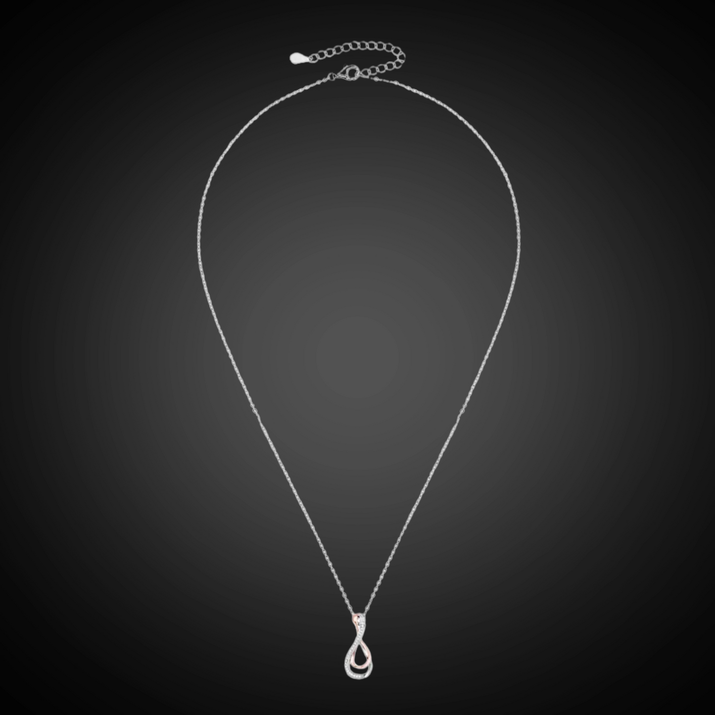 Silver necklace with a teardrop pendant on a black background