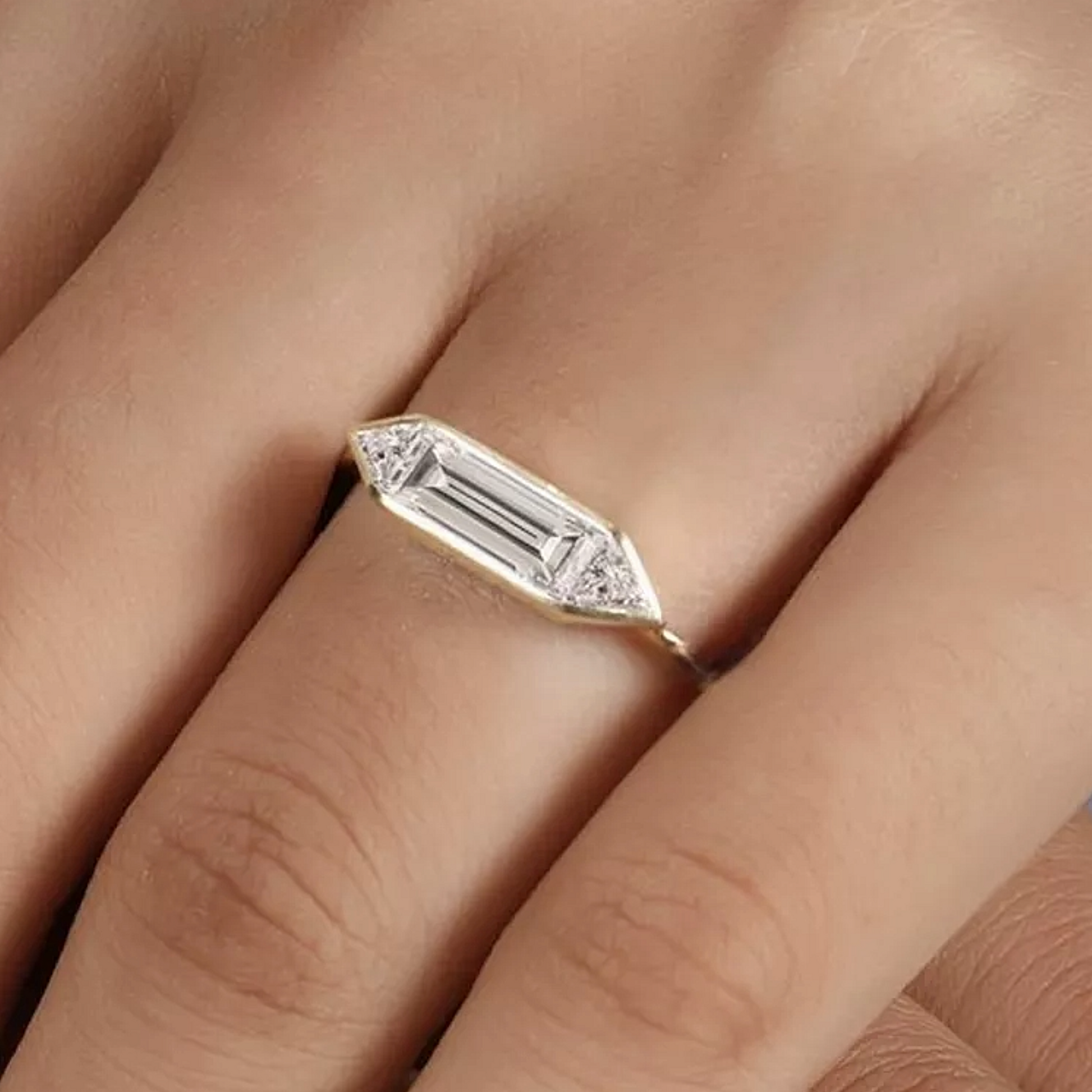 Gold ring with a diamond on a finger