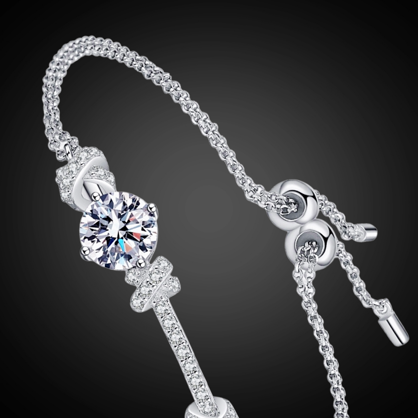 Silver bracelet with key charm on a dark background