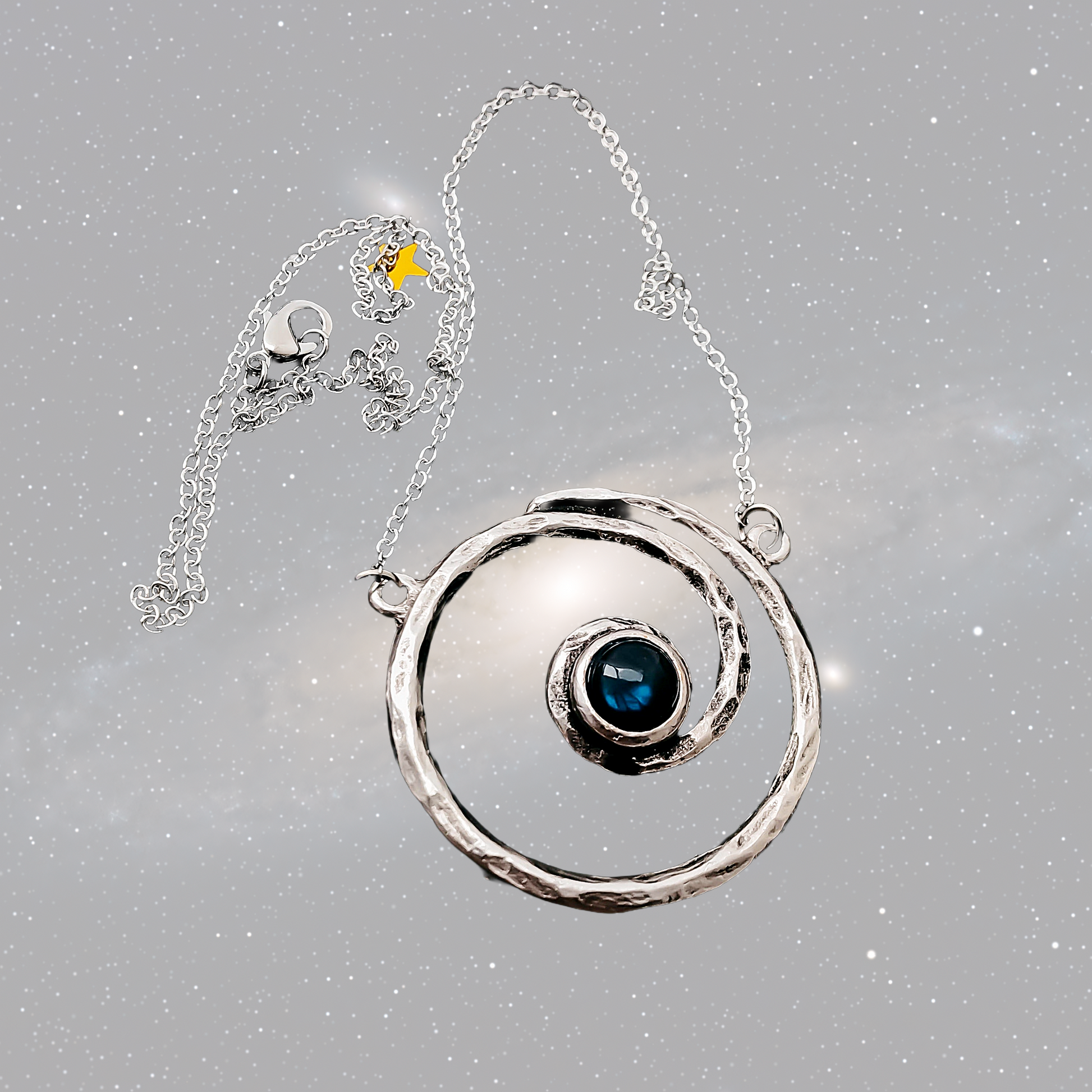 Silver necklace with a circular pendant featuring a blue gemstone on a gray background